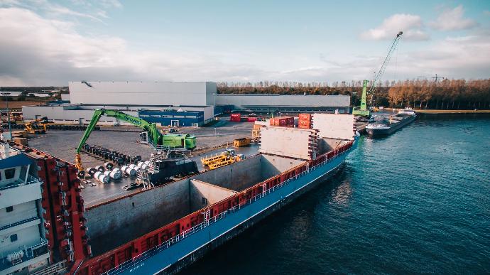 Aerial view of a ship being loaded by a crane