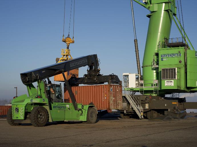 A material handler lifting a container